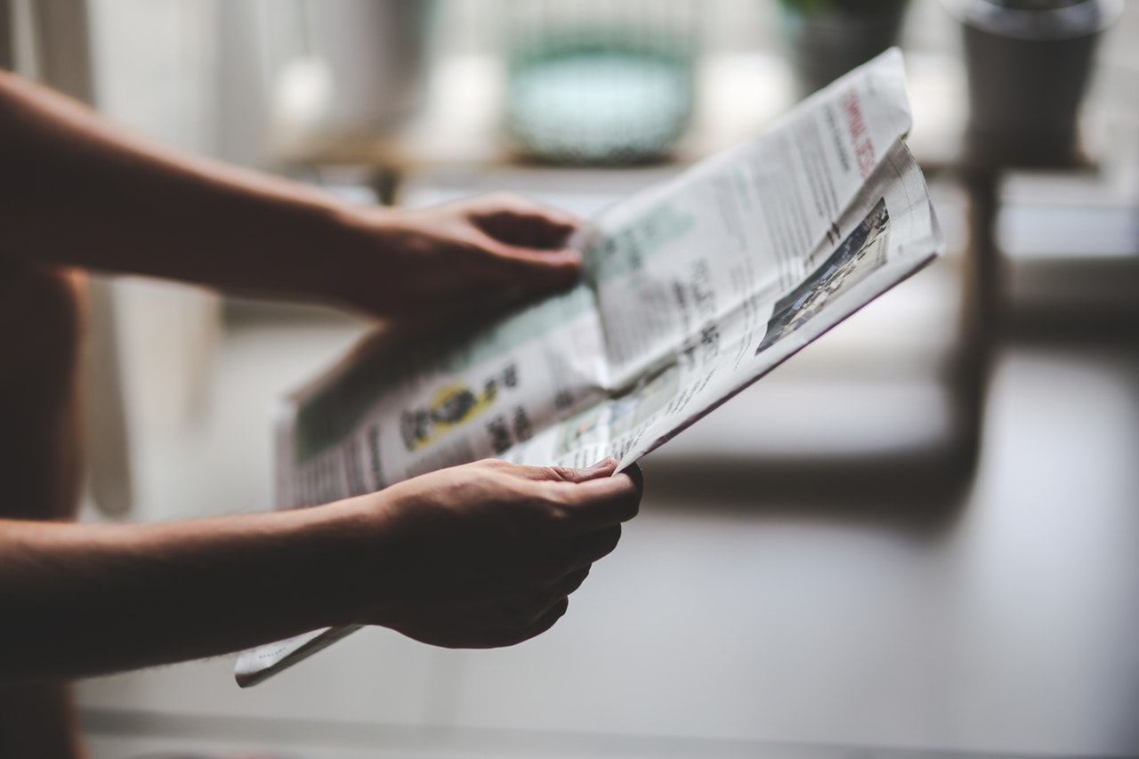 Man reading article in newspaper